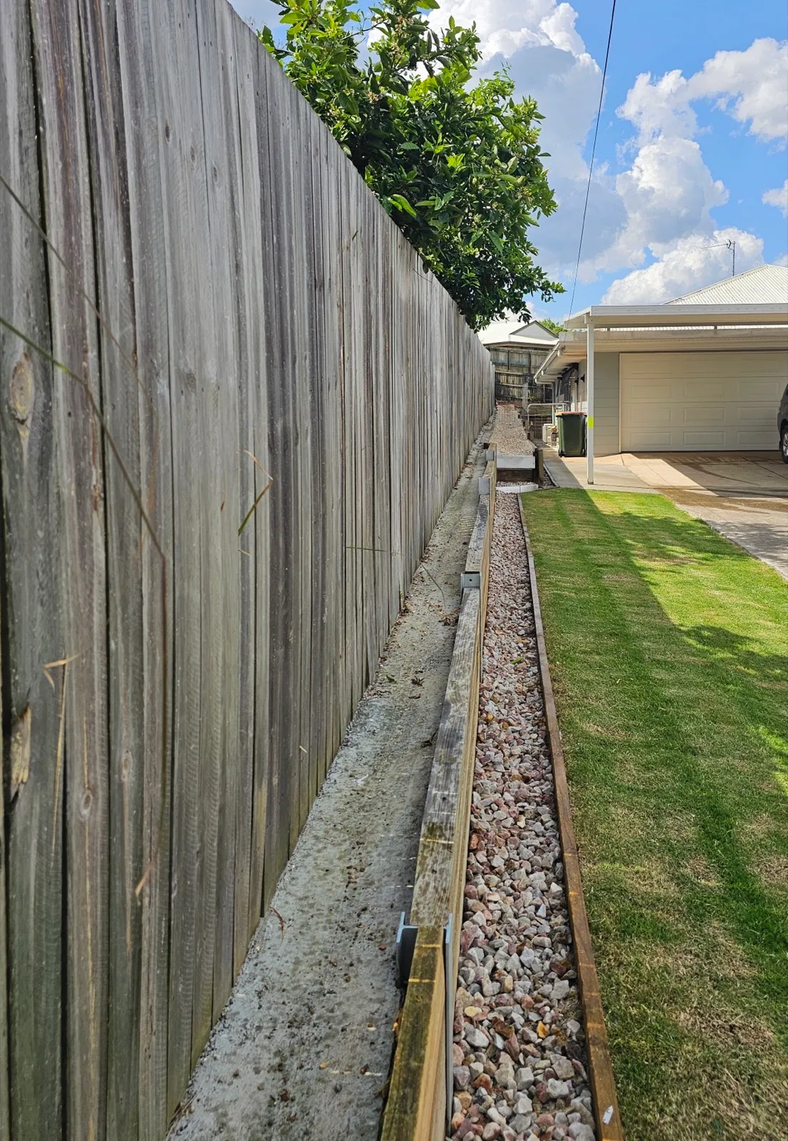 Gravel drainage border installed along fence line