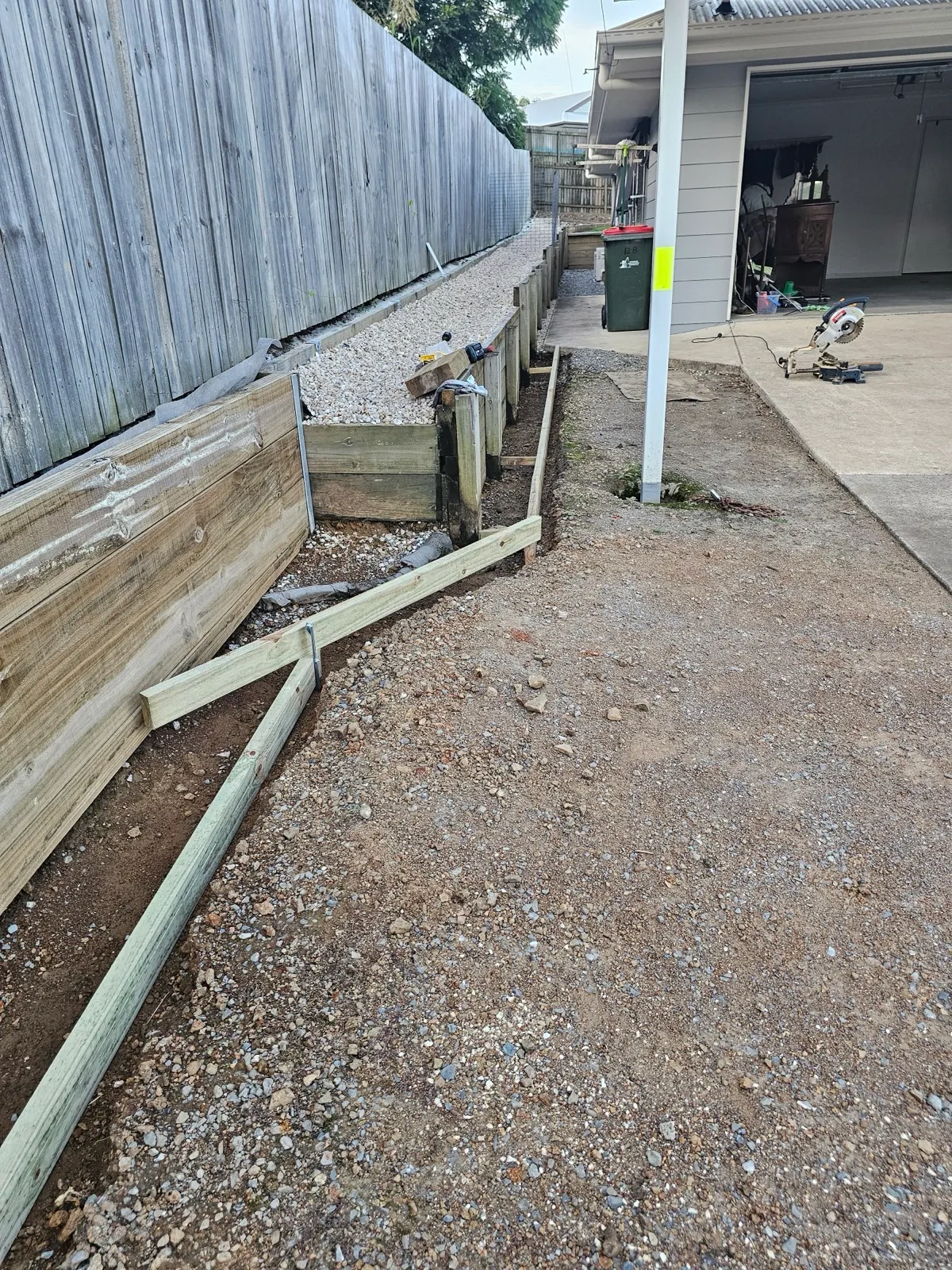 Timber retaining wall along driveway