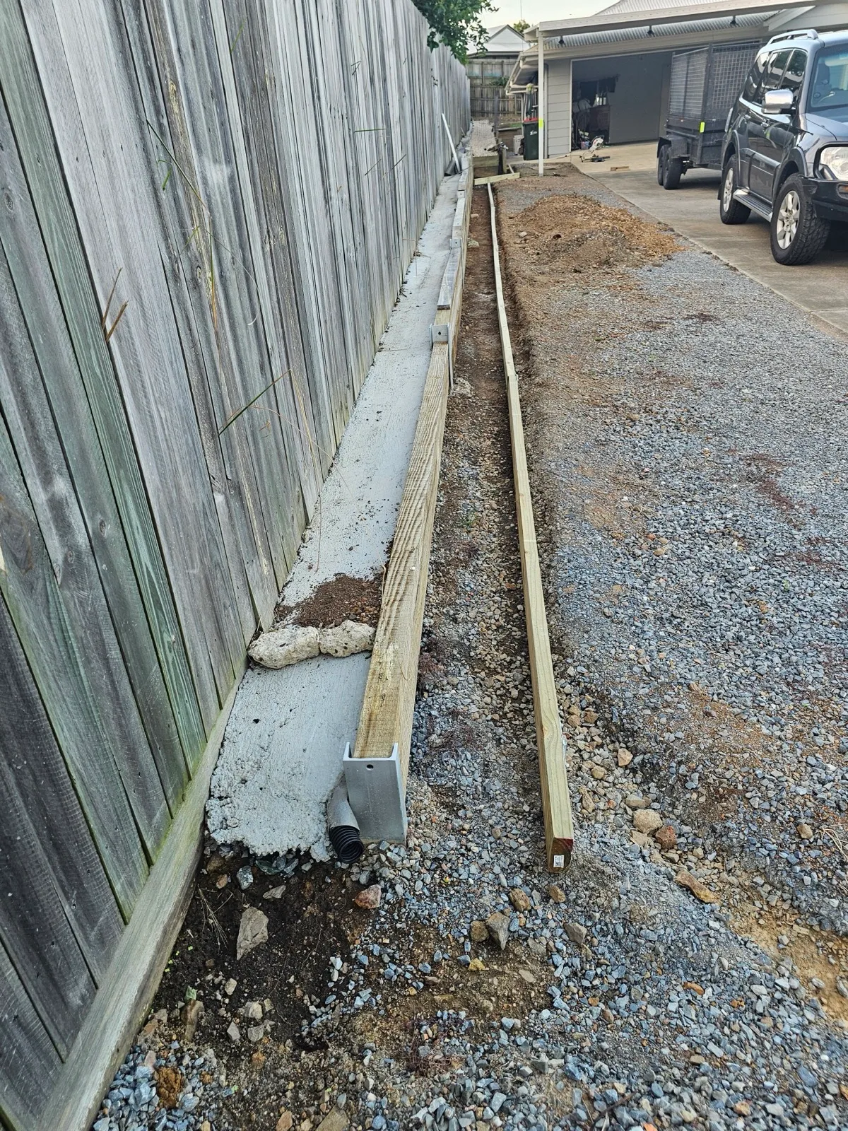 Concrete post and steel fence line installation