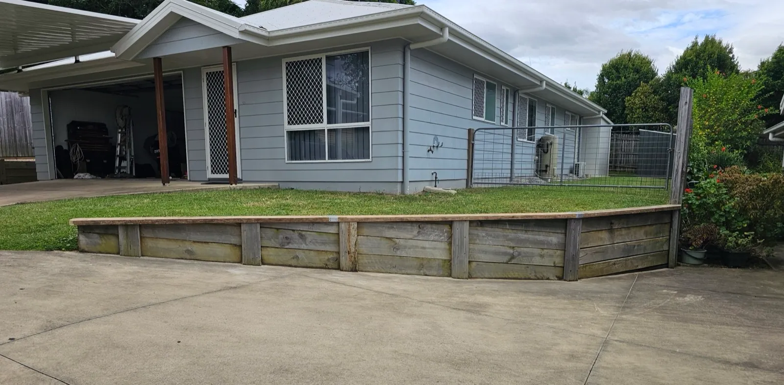 Timber sleeper retaining wall front yard — after