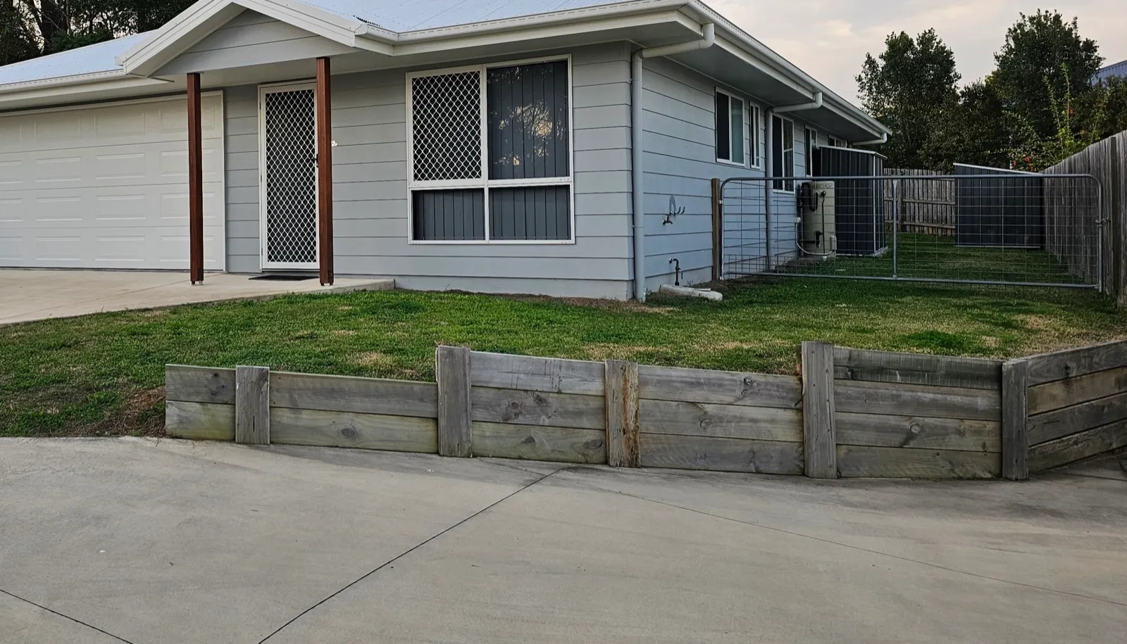 Timber sleeper retaining wall front yard — before