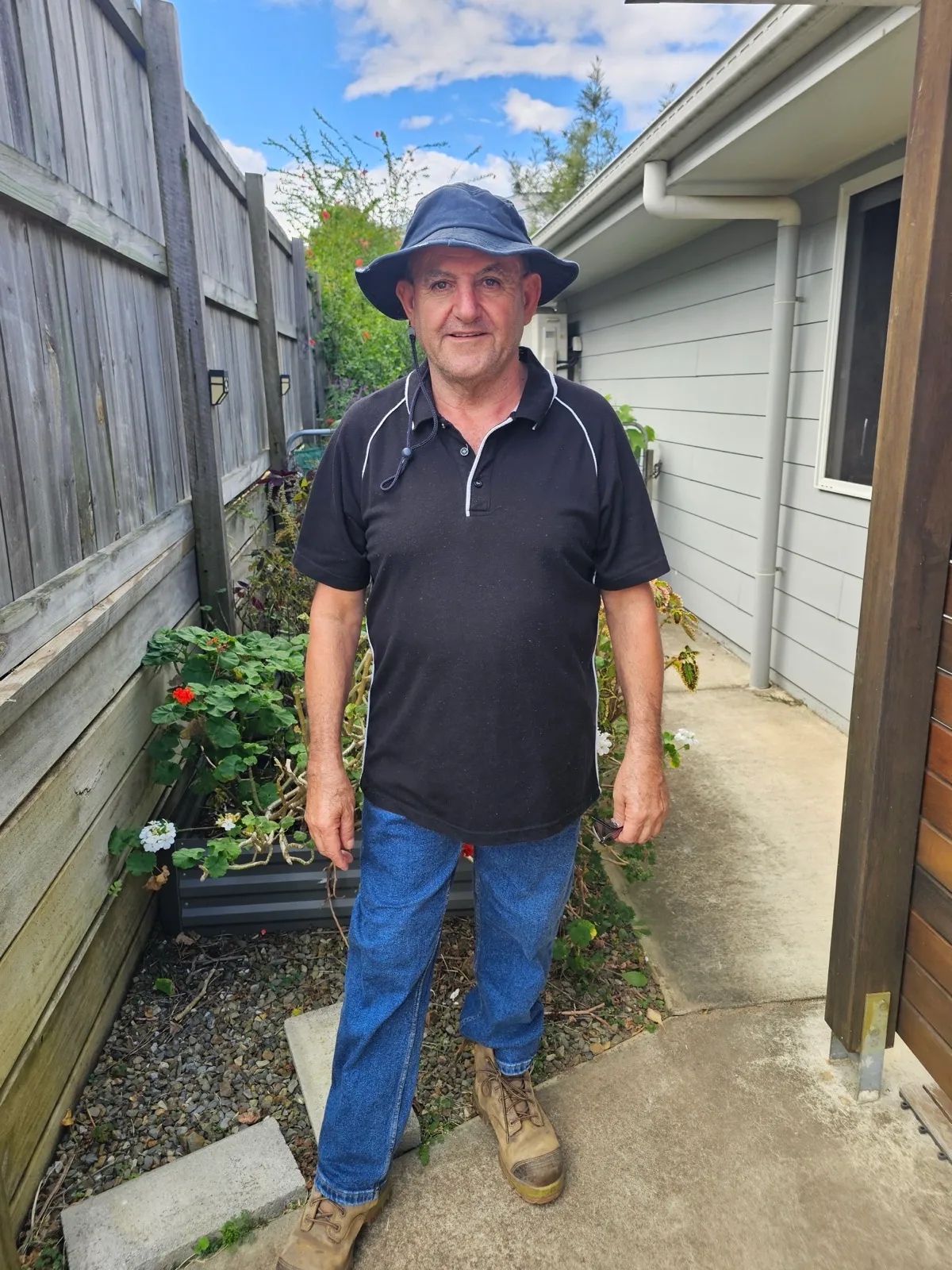 Ross Gullotta, owner of Rosco's Home and Garden, smiling in a Queensland garden
